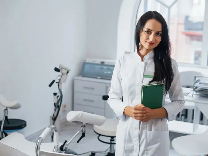 Smiling female doctor in a bright clinic holding a folder, showing CityBiz Today helping locals find trusted healthcare providers